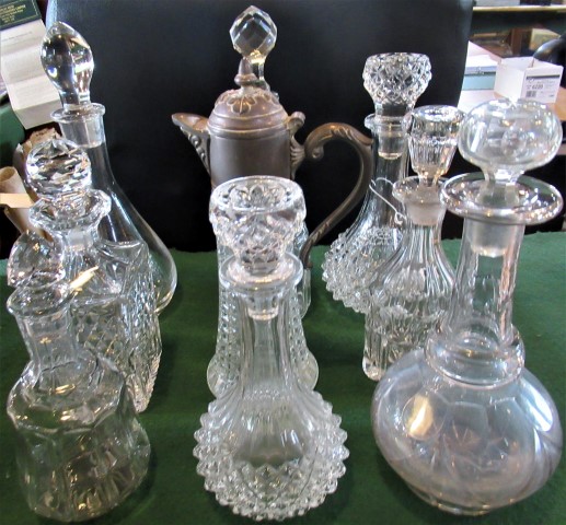 Nine miscellaneous cut and moulded glass decanters.