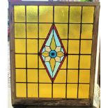 A 19th century wooden framed leaded glass window with stained glass central panel.