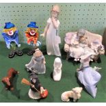 A collection of cabinet ornaments to include: a pair of Murano glass clowns, a Lladro group,