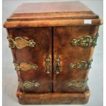 A 19th century walnut table cabinet, with brass hinged doors opening to reveal four long drawers.