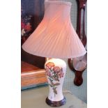 A 20th century table lamp in the Moorcroft style.