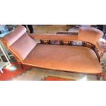 An Edwardian mahogany and inlaid chaise longue with terracotta upholstery.