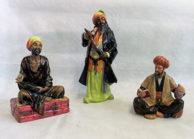 Three Royal Doulton figurines; Omar Khayam HN2247, Bluebeard HN2015 and Medicant HN1365.