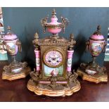 A 19th century three piece ormolu clock garniture, the whole decorated with enamel column supports,