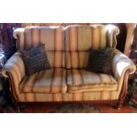 A reproduction mahogany framed and upholstered two seater settee.
