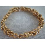 A 9ct gold two colour rope twist bracelet,having concealed clasp.