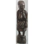 A mid-20th century African carving of a native lady carrying fruit, carved on the base Rodiase 1970.