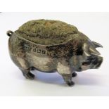 A silver pin cushion in the form of a pig, Birmingham 1902, 3.5cms high.