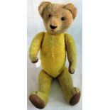 An early 20th century gold plush teddy bear.