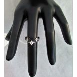 A 9ct white gold sapphire and diamond set lady;s ring of wishbone design.