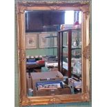 A gilt framed wall mirror.