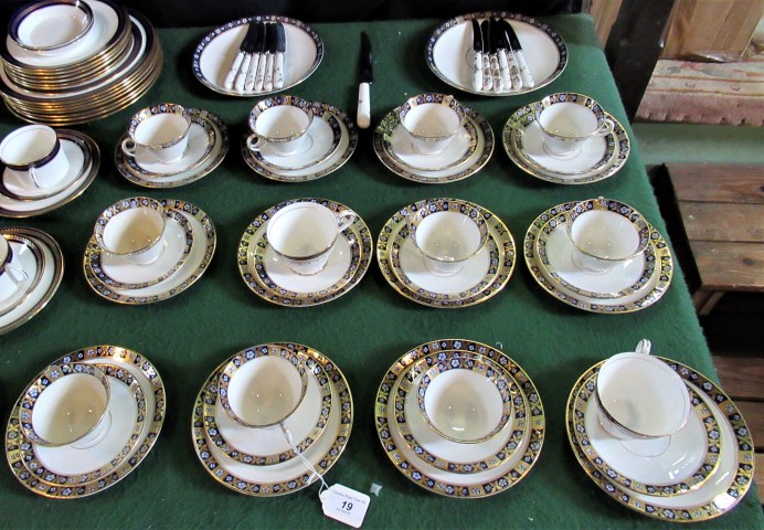 A set of twelve near matching trios with gold and blue decoration on a white ground,