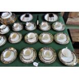 A set of twelve near matching trios with gold and blue decoration on a white ground,