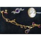 An amethyst glass seven stone necklace,