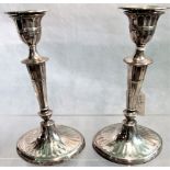 A pair of silver candlesticks of Georgian ovoid column design with band and fluted stem,