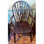 A 20th century painted wheel back Windsor armchair.