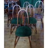 A set of six oak stick back dining chairs (2 carvers, 6 standard).