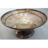 A silver tazza, the plain dish over circular stepped base, Birmingham 1938.