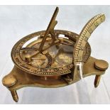 A reproduction brass nautical compass.