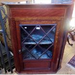 A 19th century oak and mahogany hanging corner cupboard,