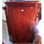 A 19th century oak and inlaid hanging corner cupboard.