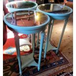 A set of three two tier occasional tables, having mirrored tops and decorated in eggshell blue.