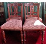 A set of four Edwardian mahogany framed dining chairs with upholstered stuffed over seats and