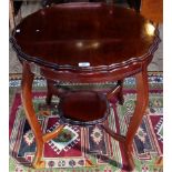 An Edwardian mahogany two tier occasional table, bearing the label R H Tucker.