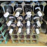 Twelve bottles of mixed red wine, to include wine rack.