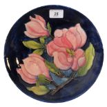 A Moorcroft plate in the Magnolia pattern, 25cm diameter.