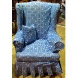 A 20th century upholstered wingback armchair.