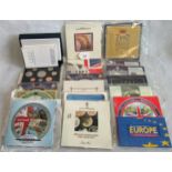 A box containing British uncirculated coin collections in wallets from 1987 - 2000 (with extras),