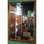 A 20th century decorative gilt framed wall mirror.