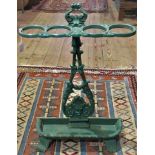 An early 20th century green painted cast iron umbrella and stick stand in the Coalbrookdale style.