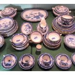 A large quantity of Old Willow pattern dinnerware, to include: tureens, meat plate, dinner plates,