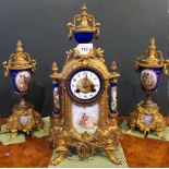 A 19th century gilt metal and porcelain clock garniture.