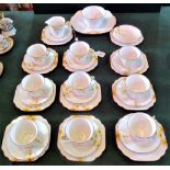 A Melba bone china tea service in the Art Deco style, comprising: nine trios, cake plate,