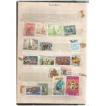 Stamp collection in green album. Variety of stamps from various countries including Pakistan,