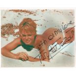 Brigitte Bardot signed 10x8 colour photo laying on a beach. Good condition. All signed items come