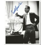 Scott Carpenter signed 10 x 8 b/w photo. Full length pose in business suit leaning against space