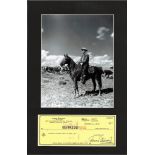 James Stewart signed cheque. Mounted below b/w photo. American actor and military officer who is
