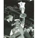 Football Kenny Sansom 10x8 signed B/W photo celebrating League cup win for Arsenal. Sansom,