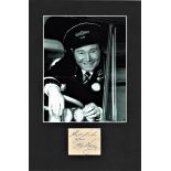 Reg Varney signature piece mounted below b/w photo from On the Buses. Approx. overall size 11x15.