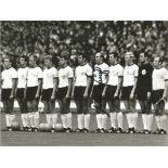 Willi Schulz Signed 8" X 6" Football Photo Depicting West German Players Lining Up Shoulder To