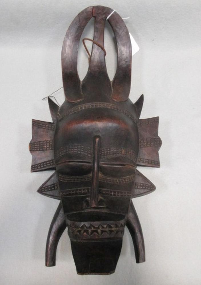 An African tribal carved wood mask Local house clearance. Chin repaired and crack to top.