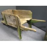 A WWII Aircraft wheel, fitted to a wood garden wheelbarrow