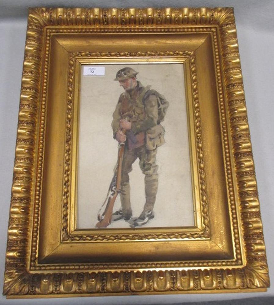 A WWI period watercolour of a British soldier in battledress, standing with head lowered, in gilt