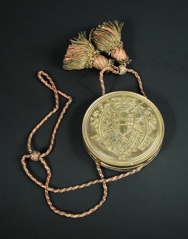 A 19th century seal box, the engraved brass circular case with wax seal interior, possibly crest for