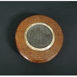 A York Minster 1829 circular oak snuff box with central bronze medallion within gold metal band