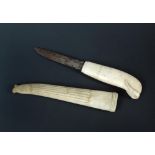 A 19th century marine ivory knife, with steel blade and sheath, the handle carved in the form of a